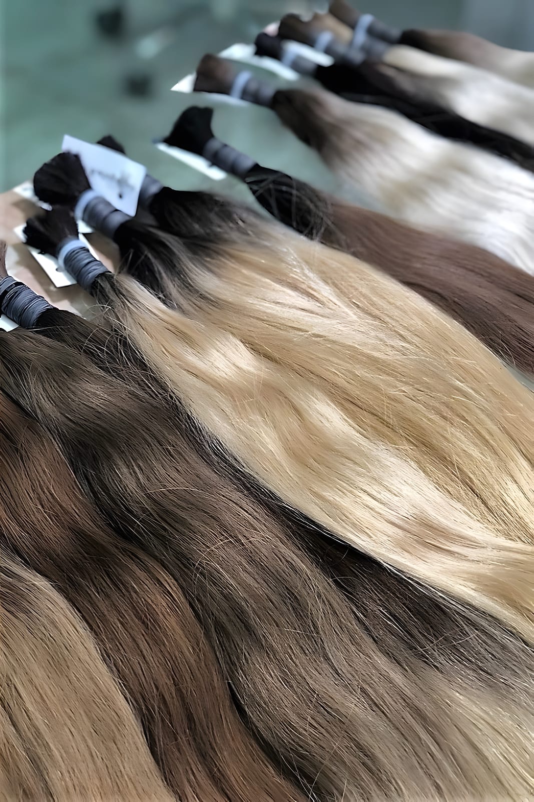 Bundles of hair extensions in shades from dark brown to blonde